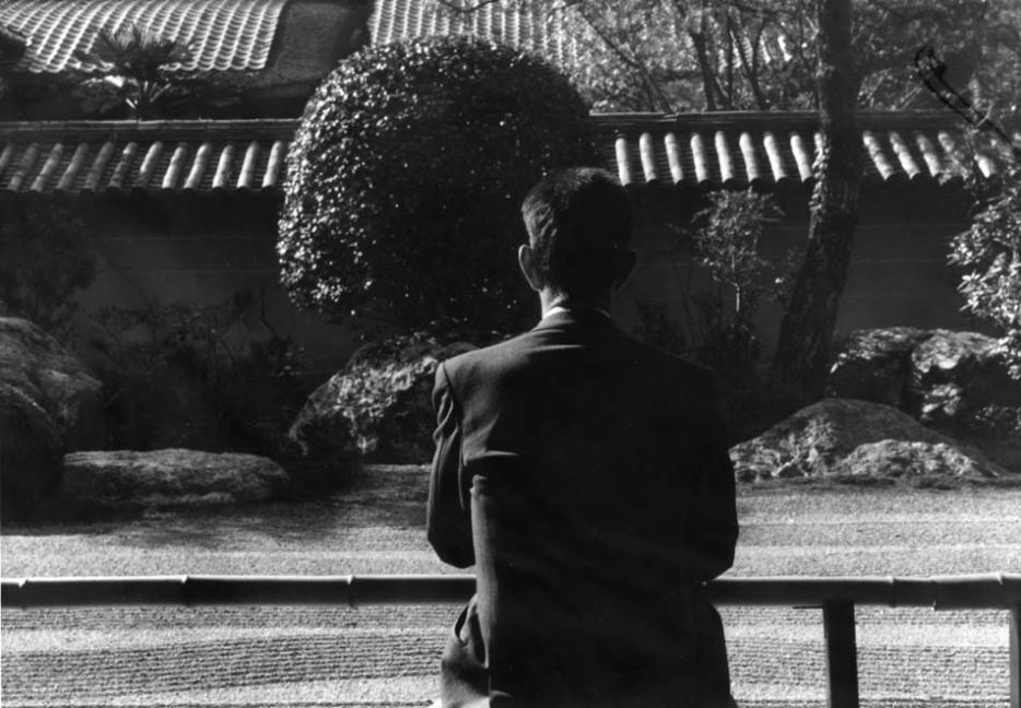 ||John Cage being studiously inactive at a Japanese rock garden.
