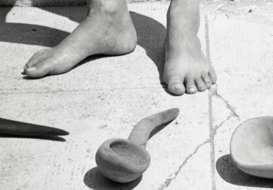 A crop of an image from Deborah Levy's book cover, a black and white photograph of feet with a spoon.