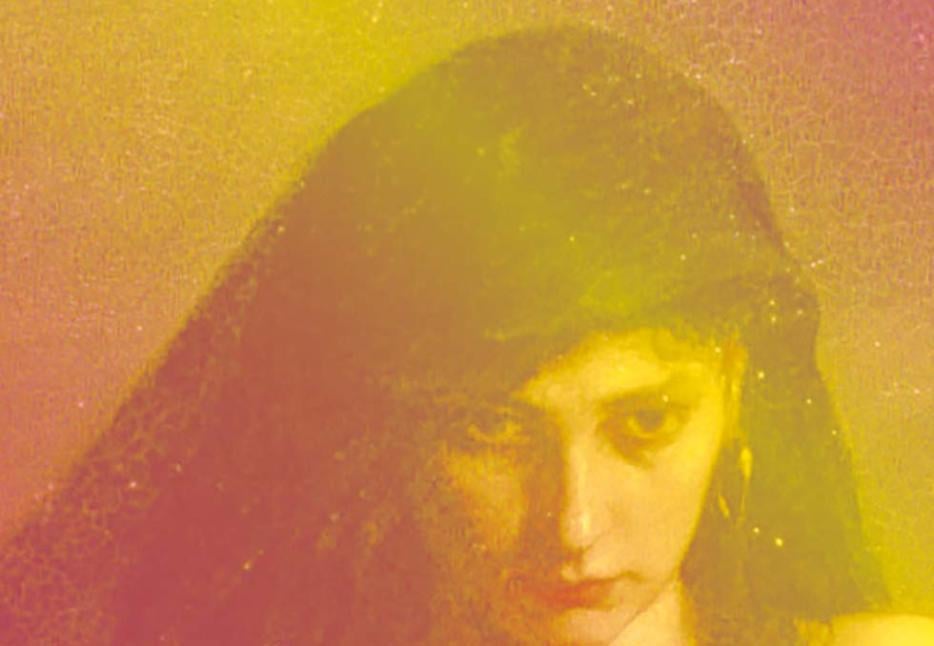 A woman staring down, with a yellow and pink cast 