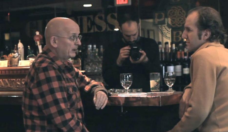 two men talking in a bar