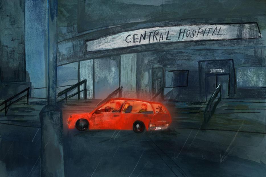 A glowing red car sits outside of a hospital