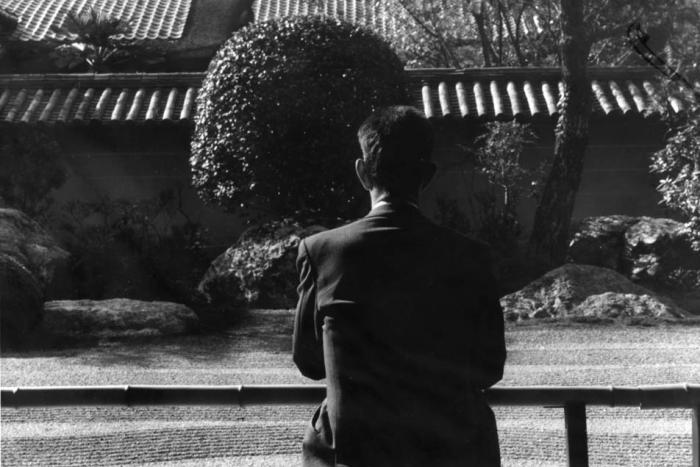 ||John Cage being studiously inactive at a Japanese rock garden.