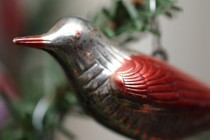 |Christmas ornament of a bird in red and silver.|Photographed by Christina Rutz