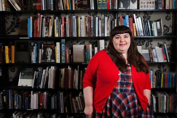 A woman in red cardigan in a library